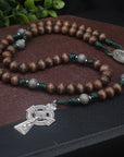 Celtic Catholic rosary with gray-brown and lunar gray wood beads, silver oxidized crucifix, and green paracord