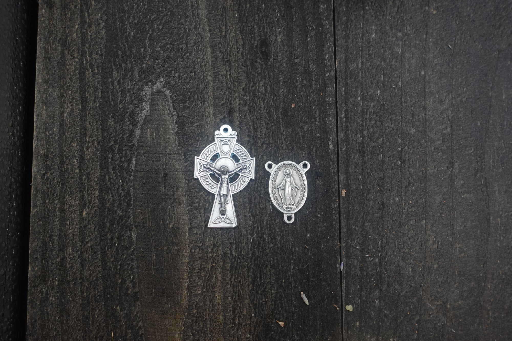 Close-up of silver oxidized Celtic crucifix on emerald green paracord rosary