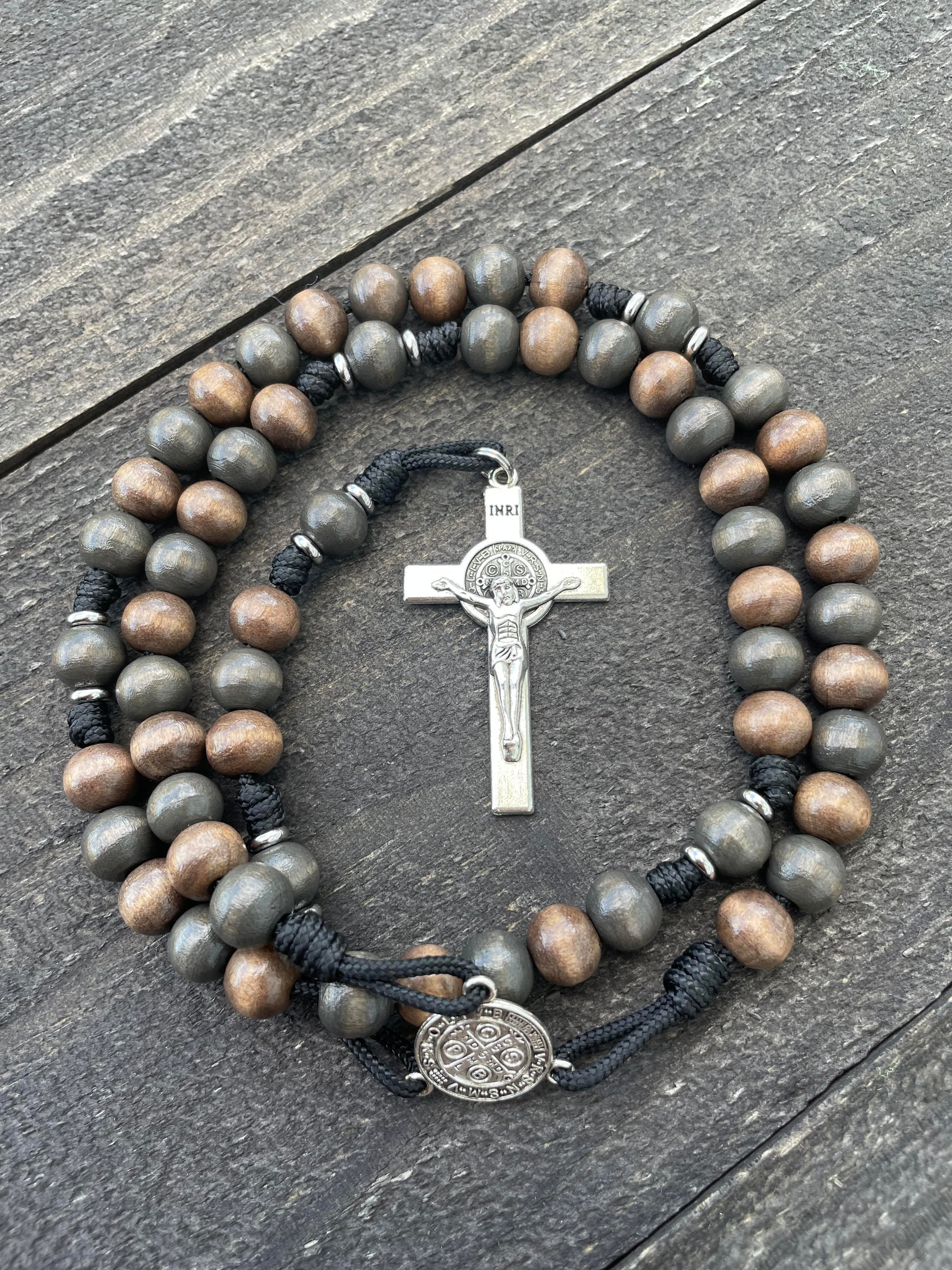 Durable black paracord rosary featuring gray-brown stained wooden beads and silver crucifix centerpiece