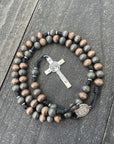 Oxidized silver St. Benedict crucifix detail on durable black paracord rosary crafted in Fargo ND
