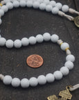 Close-up of white wooden beads and gold spacers on Heavenly Grace rosary showing heirloom craftsmanship
