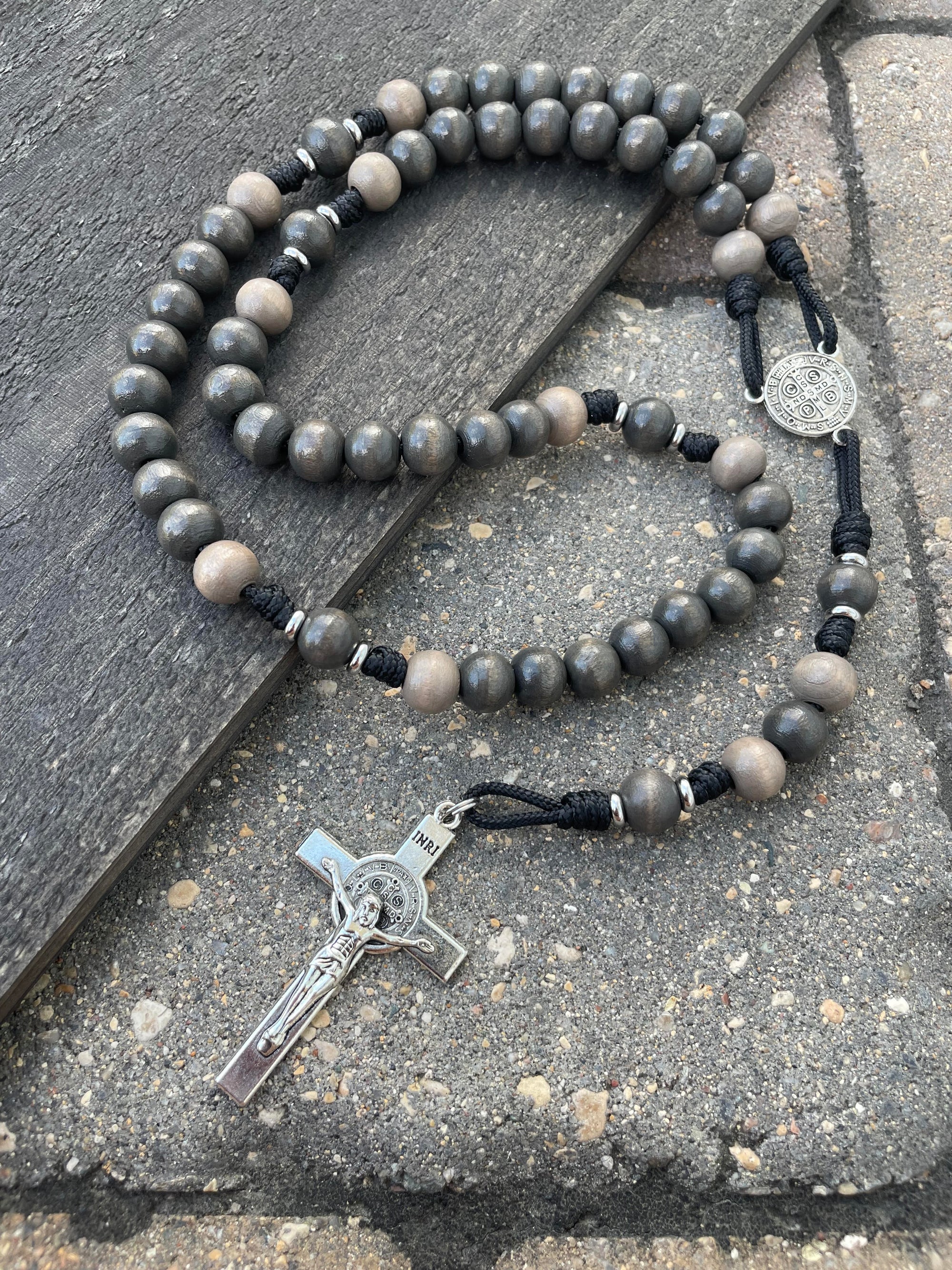 Rosary for the Holy Souls with light gray and charcoal wooden beads, silver St. Benedict crucifix, and black paracord