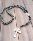 Handcrafted rosary featuring gray-blue and gray wood beads with silver crucifix and Miraculous Medal centerpiece
