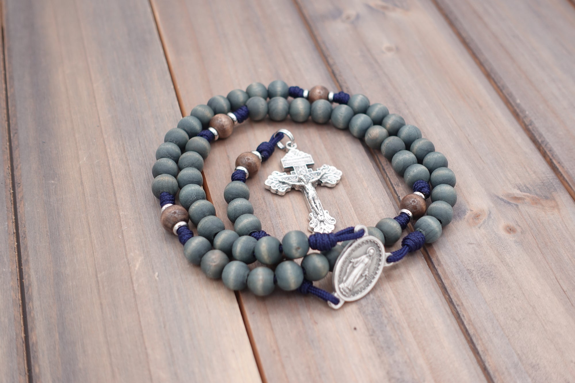 Durable paracord rosary built for daily prayer with silver hardware and gray-blue stained wooden beads