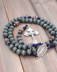 Durable paracord rosary built for daily prayer with silver hardware and gray-blue stained wooden beads