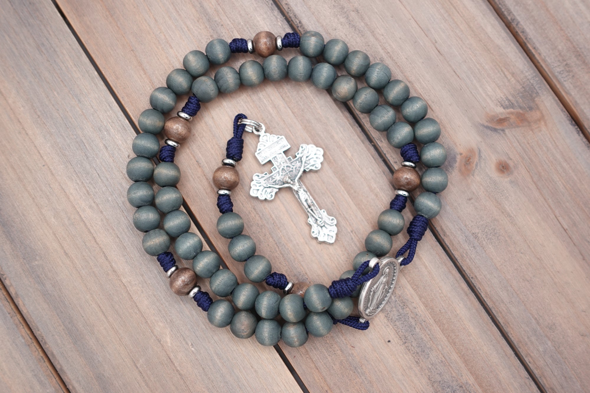 Silver crucifix detail symbolizing strength and devotion on handmade King of Glory rosary