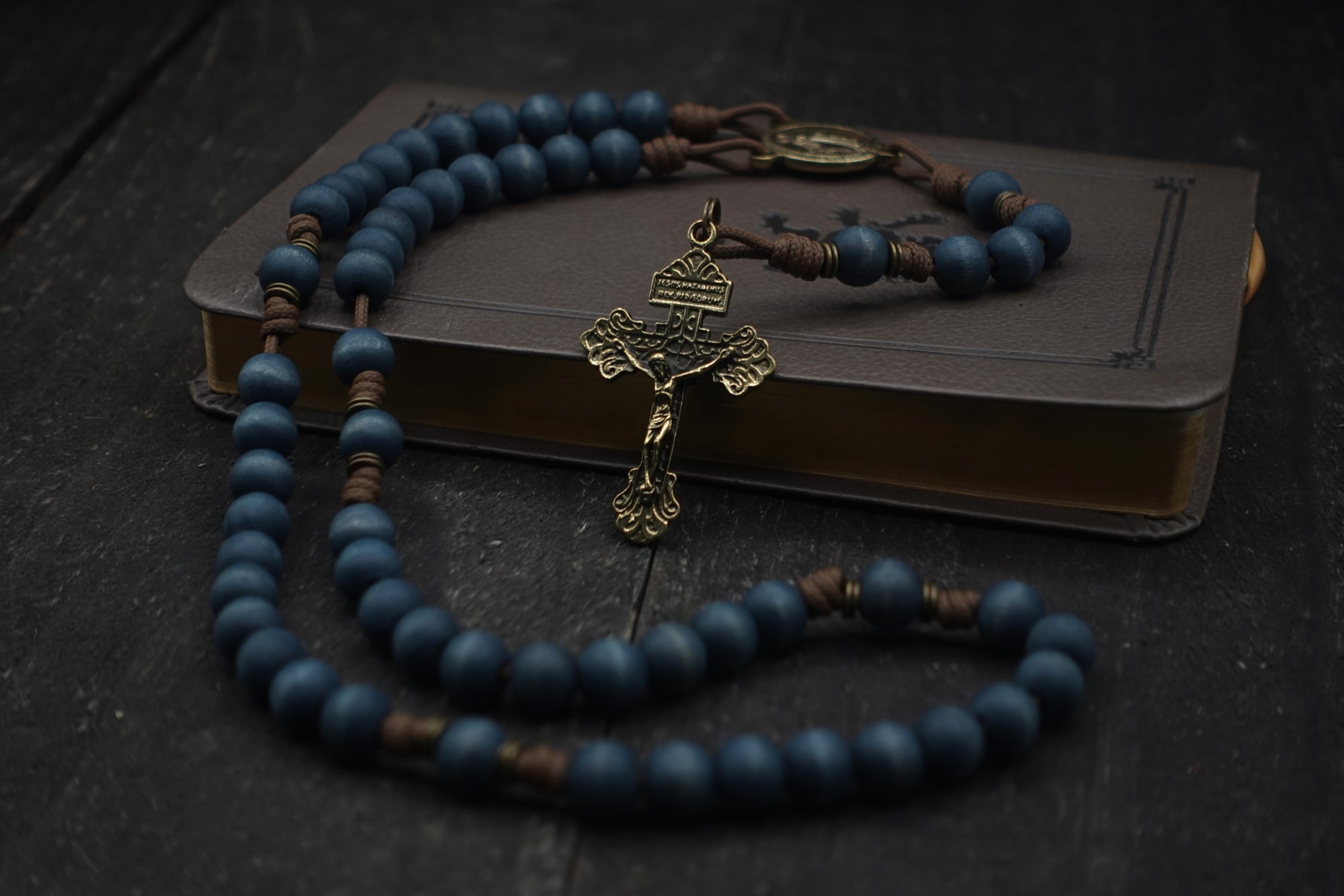 Handcrafted rosary featuring blue wood beads with bronze crucifix and Miraculous Medal centerpiece