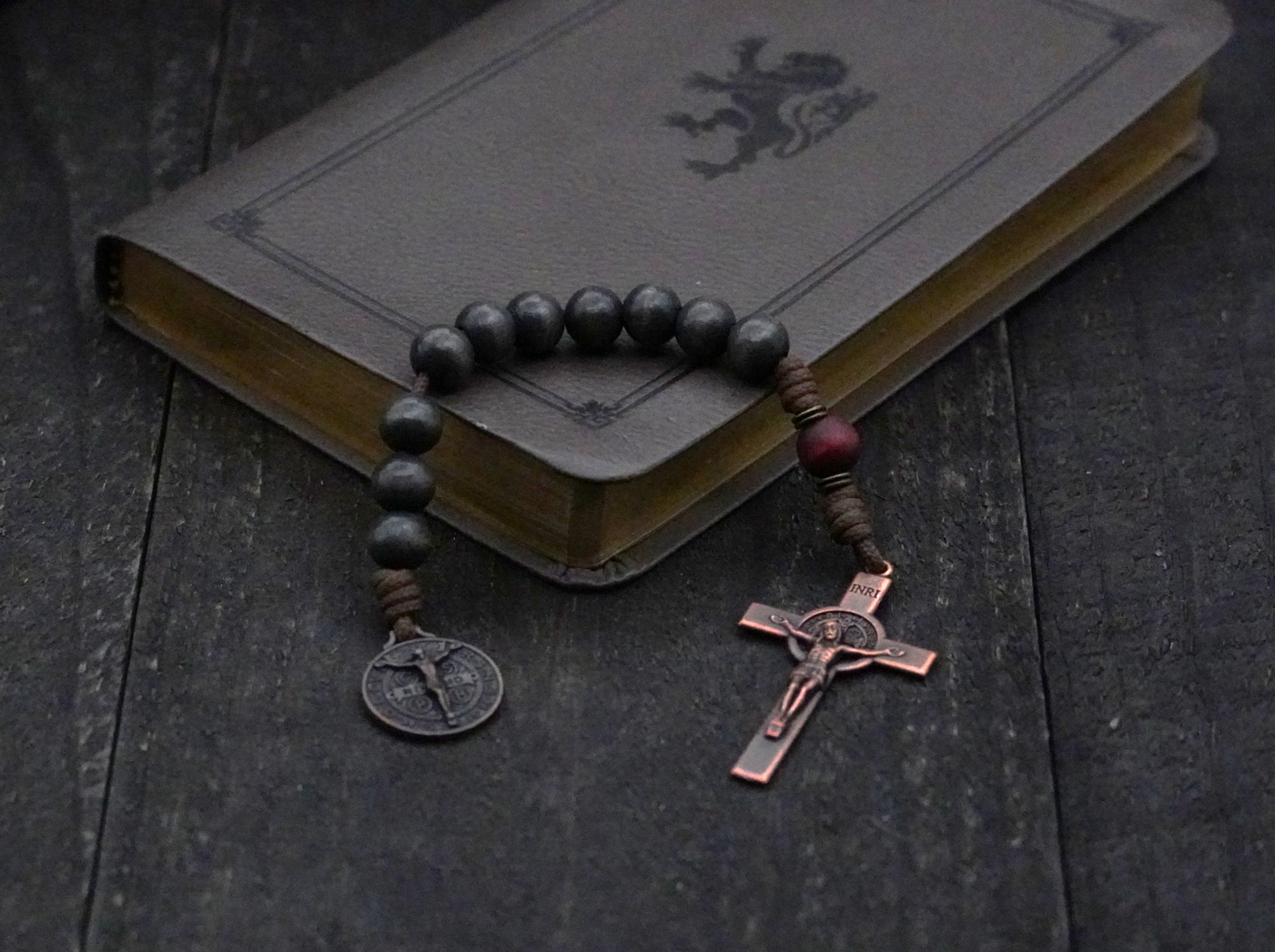 Pocket Logos rosary with charcoal and red-brown wooden beads, bronze Pardon Crucifix, and Miraculous Medal