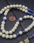 Detailed view of white wood beads with bronze accents on lavender paracord womens rosary