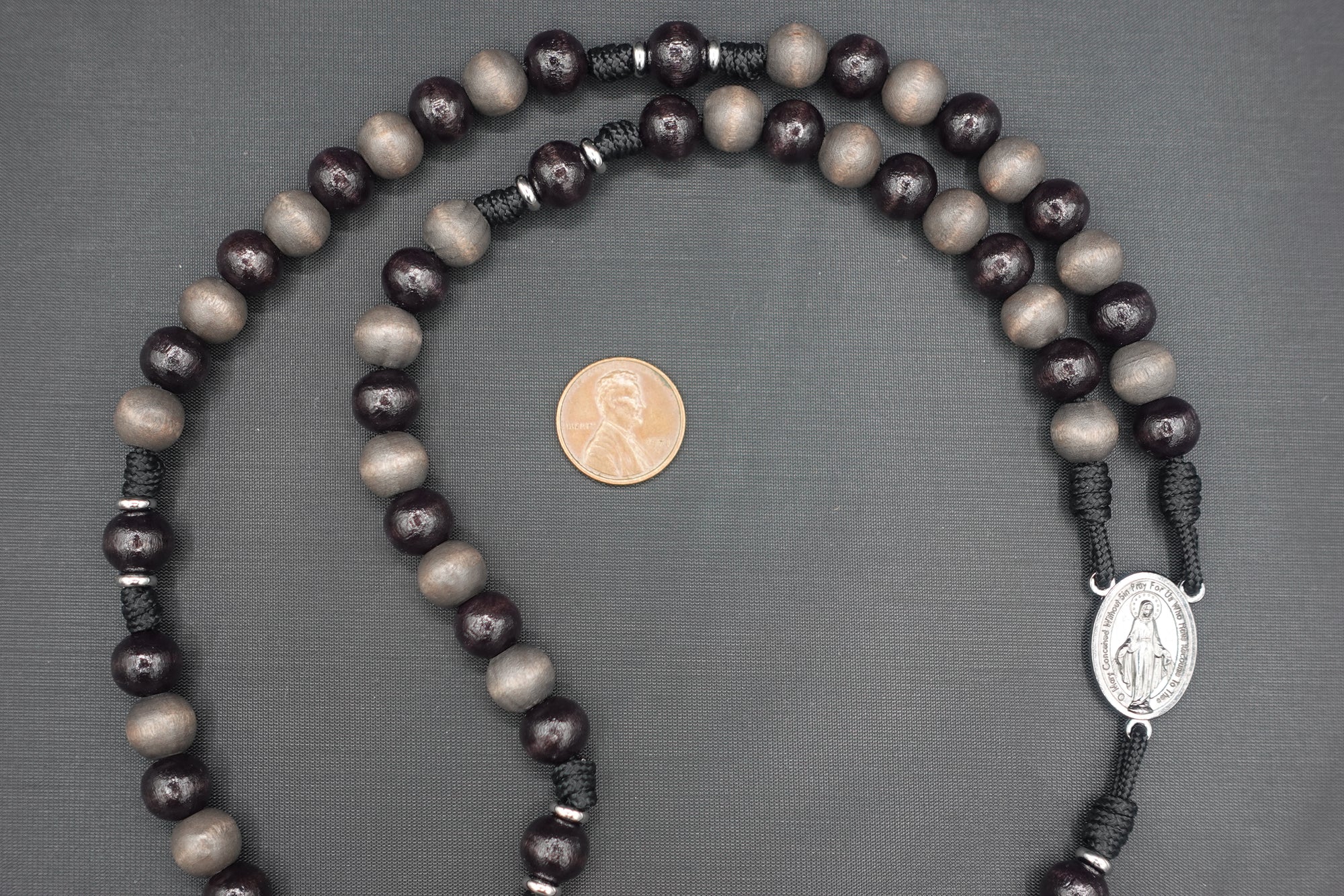 Wood bead detail showing unique tones and grain on handmade Memento Mori rosary