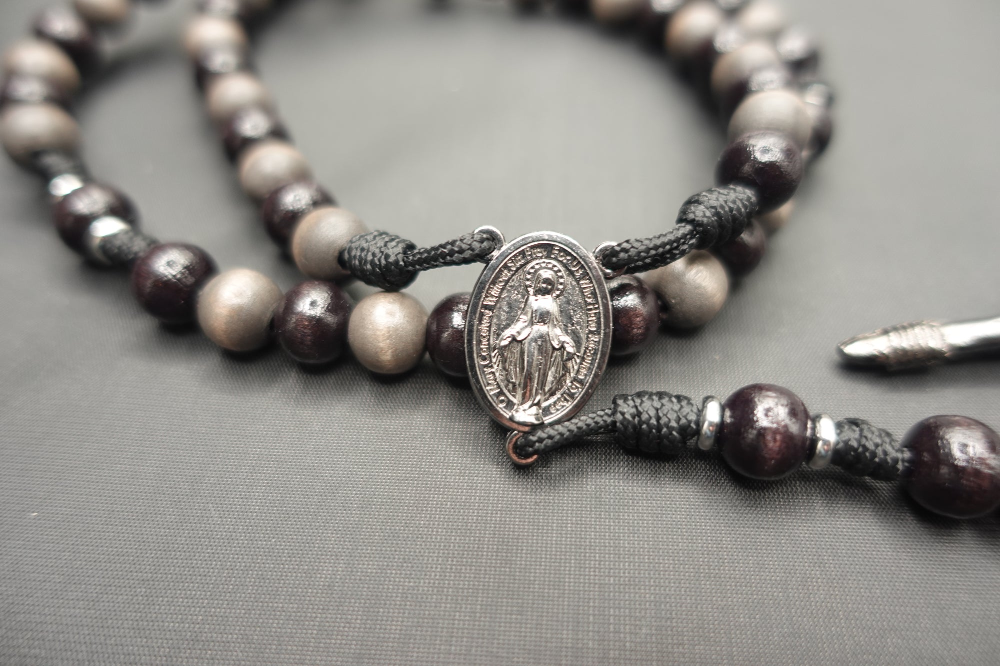 Miraculous Medal centerpiece detail on Memento Mori rosary with silver hardware and wooden beads