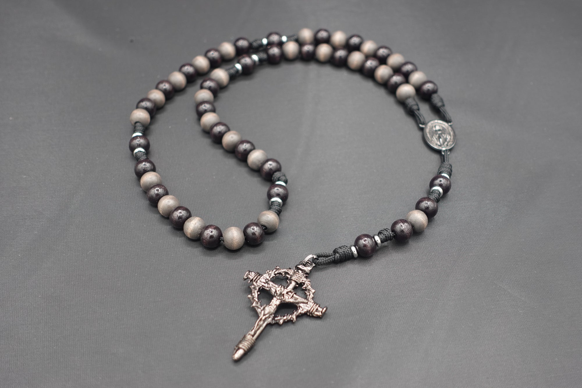 Handcrafted Memento Mori rosary for daily prayer featuring silver crucifix and gray-brown wood beads
