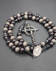 Memento Mori rosary by Runewood Rosary combining dark wooden beads and silver crucifix for faithful devotion