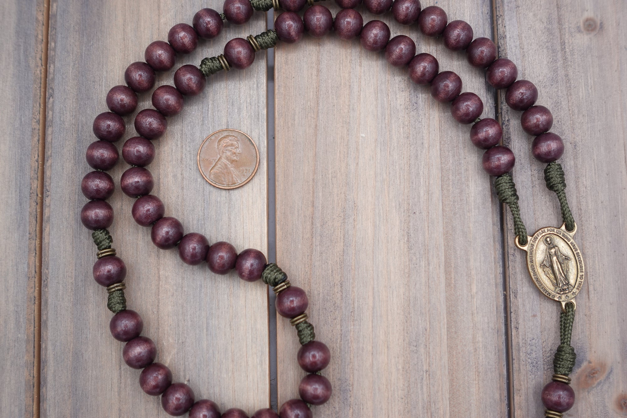 Wood bead and bronze spacer detail showing natural stain variation on handmade Mount of Olives rosary