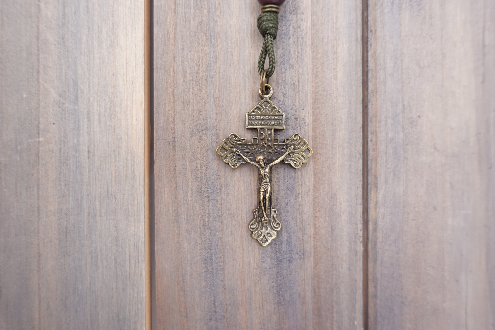 Bronze crucifix detail symbolizing faith and devotion on handmade Mount of Olives rosary