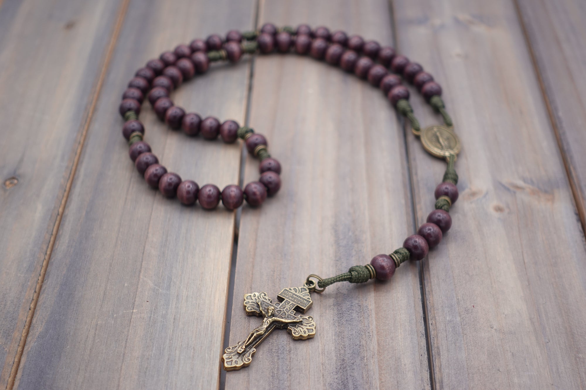Mount of Olives rosary by Runewood Rosary combining burgundy wood beads, bronze crucifix, and olive paracord for faithful devotion
