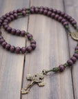 Mount of Olives rosary by Runewood Rosary combining burgundy wood beads, bronze crucifix, and olive paracord for faithful devotion