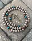 Handcrafted Noel Christmas rosary for daily prayer featuring bronze crucifix and teal-gray wood beads