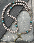 Rugged handmade Noel christmas rosary built for daily prayer with bronze crucifix and teal wood beads