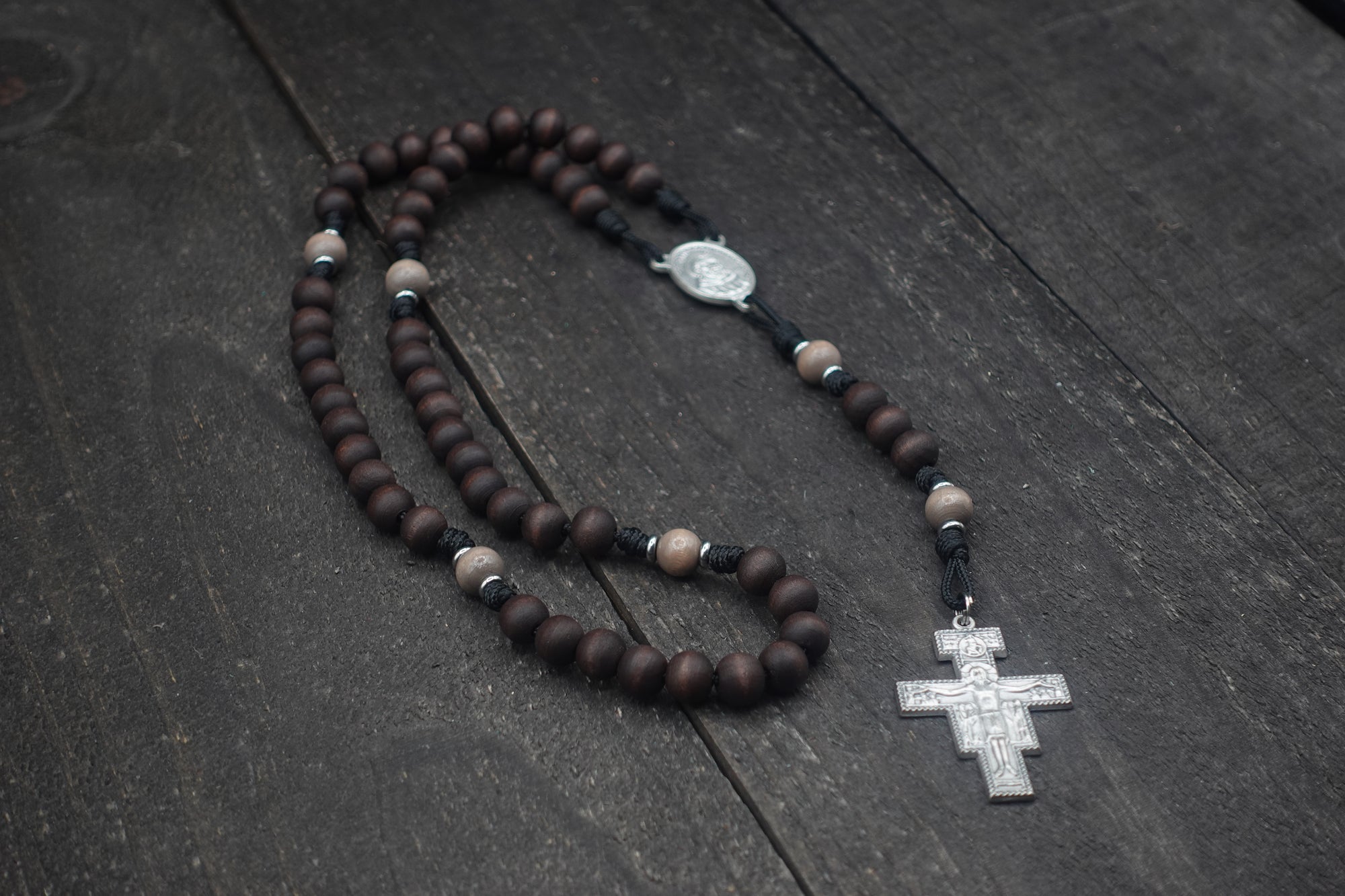 Handcrafted Padre Pio rosary for daily prayer featuring silver crucifix and walnut wood beads