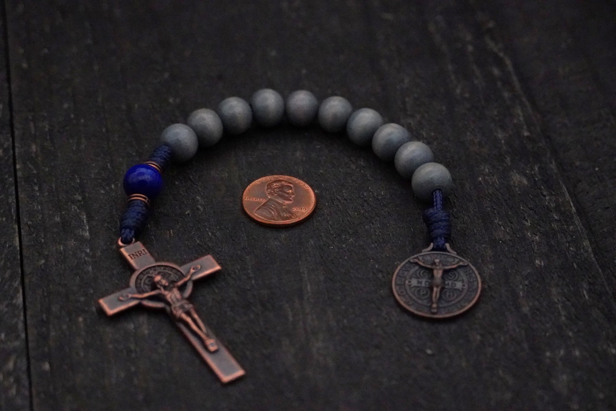 Durable navy paracord rosary with lunar and royal blue stained beads and copper hardware built to last