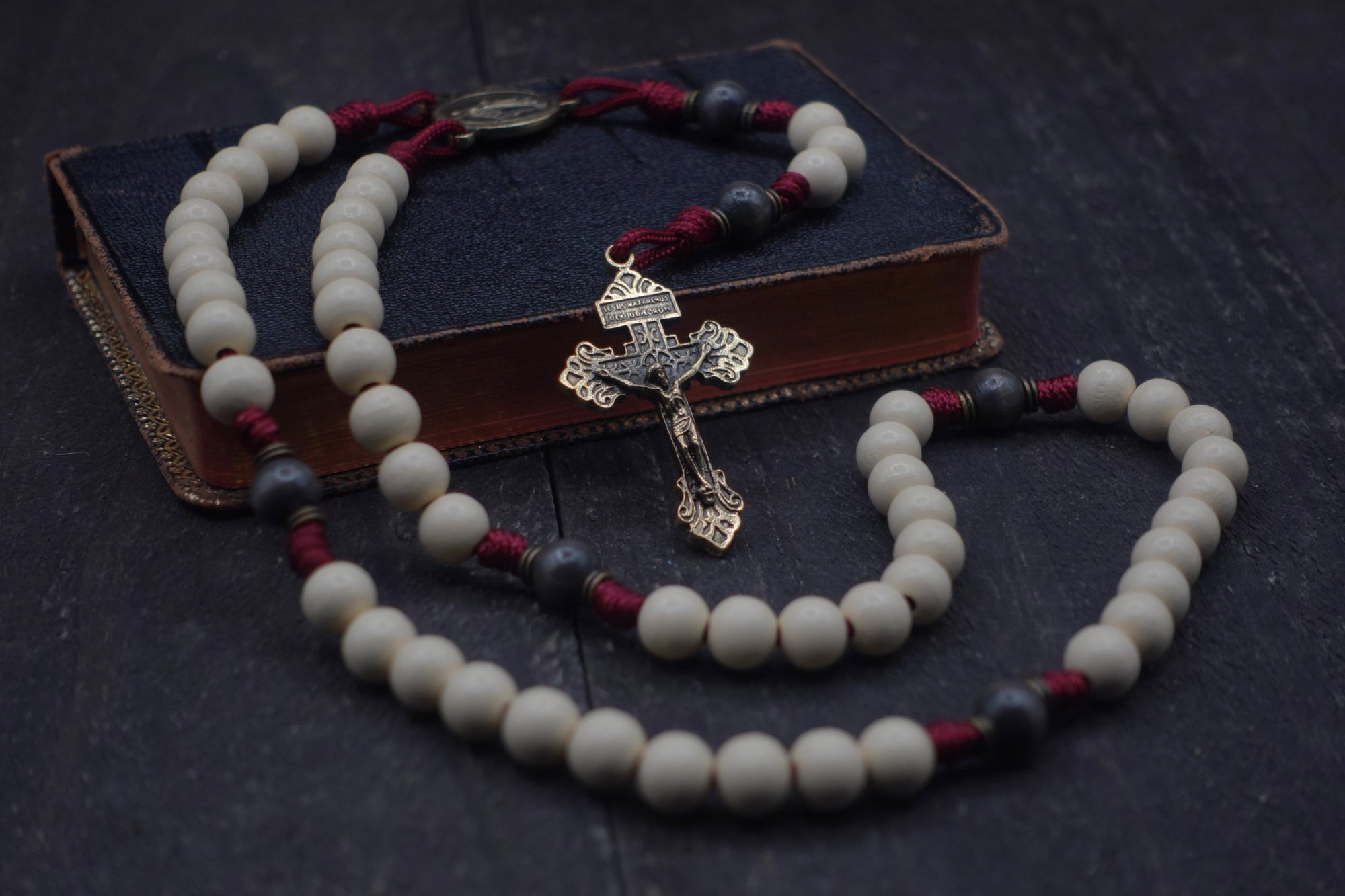 Pope Leo XIV rosary with vintage white and charcoal wooden beads, bronze Pardon crucifix, and burgundy paracord