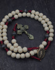 pope Leo XIV rosary by Runewood Rosary combining white and charcoal wood beads, bronze crucifix, and burgundy paracord for faithful devotion