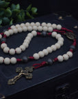 Close-up of vintage white and charcoal wooden beads on Pope Leo XIV rosary showing heirloom craftsmanship