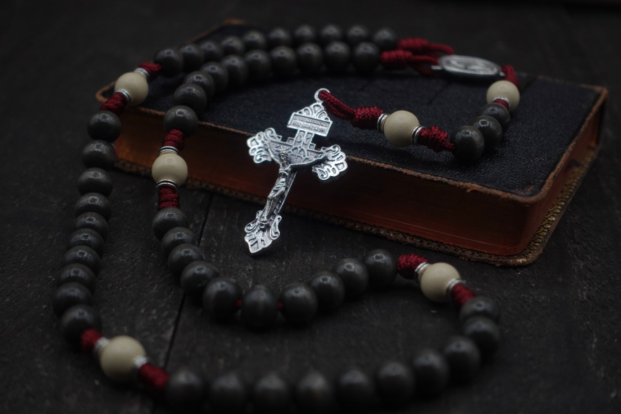 Pope Leo XIV rosary with charcoal and white wooden beads, silver Pardon crucifix, and burgundy paracord