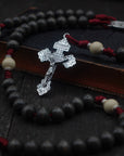 Pope Leo XIV rosary with charcoal and white wooden beads, silver Pardon crucifix, and burgundy paracord