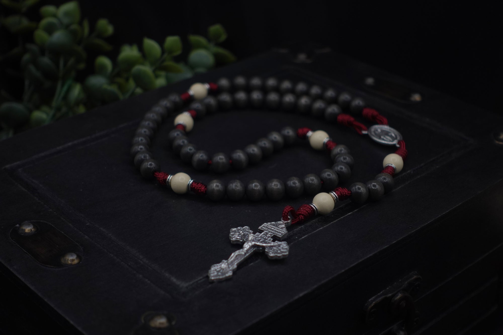 Handcrafted rosary inspired by Pope Leo XIV featuring charcoal-stained wood beads and silver crucifix centerpiece