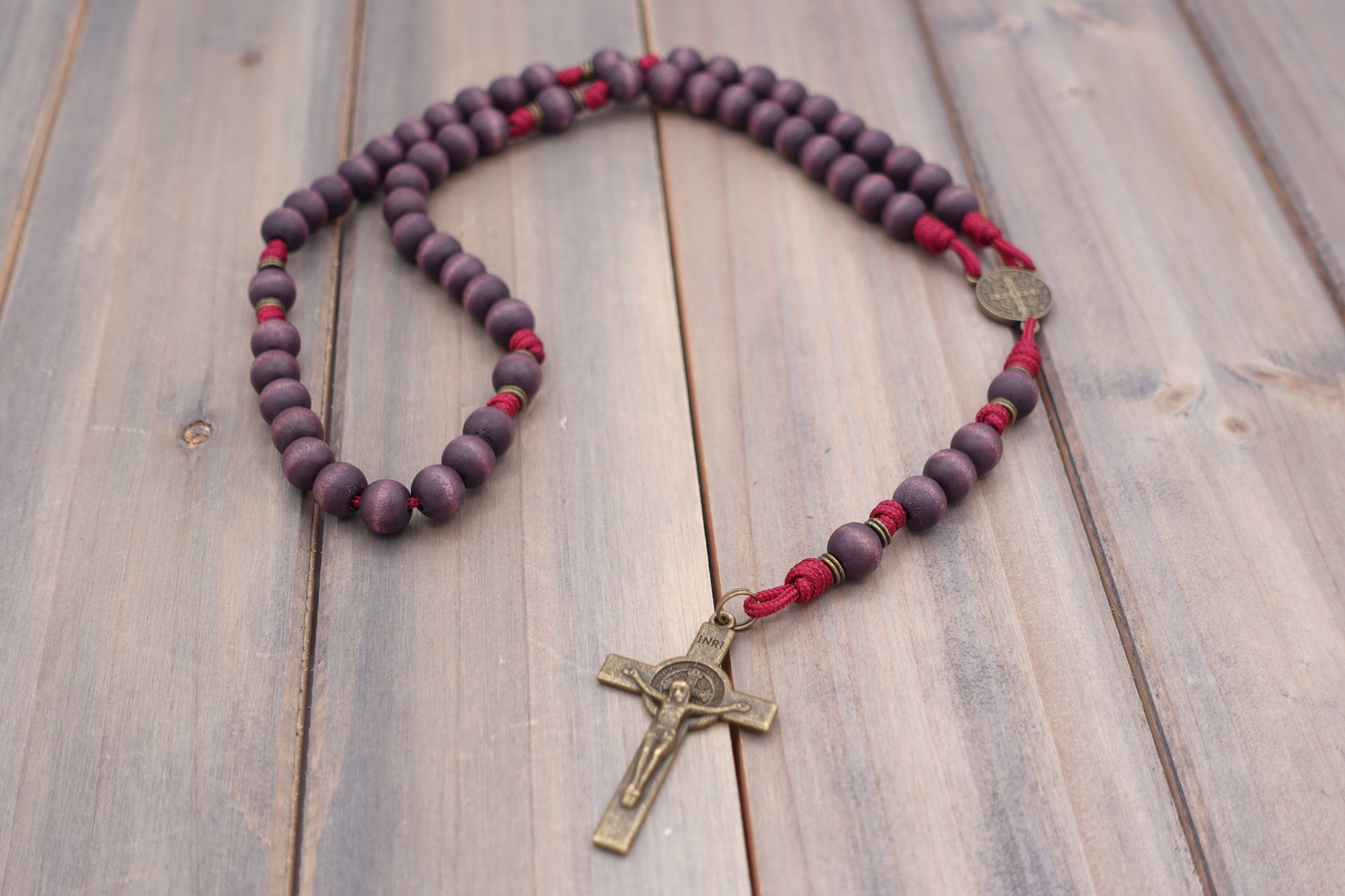 Roma Victor rosary with purple wooden beads, bronze St. Benedict crucifix, and durable paracord