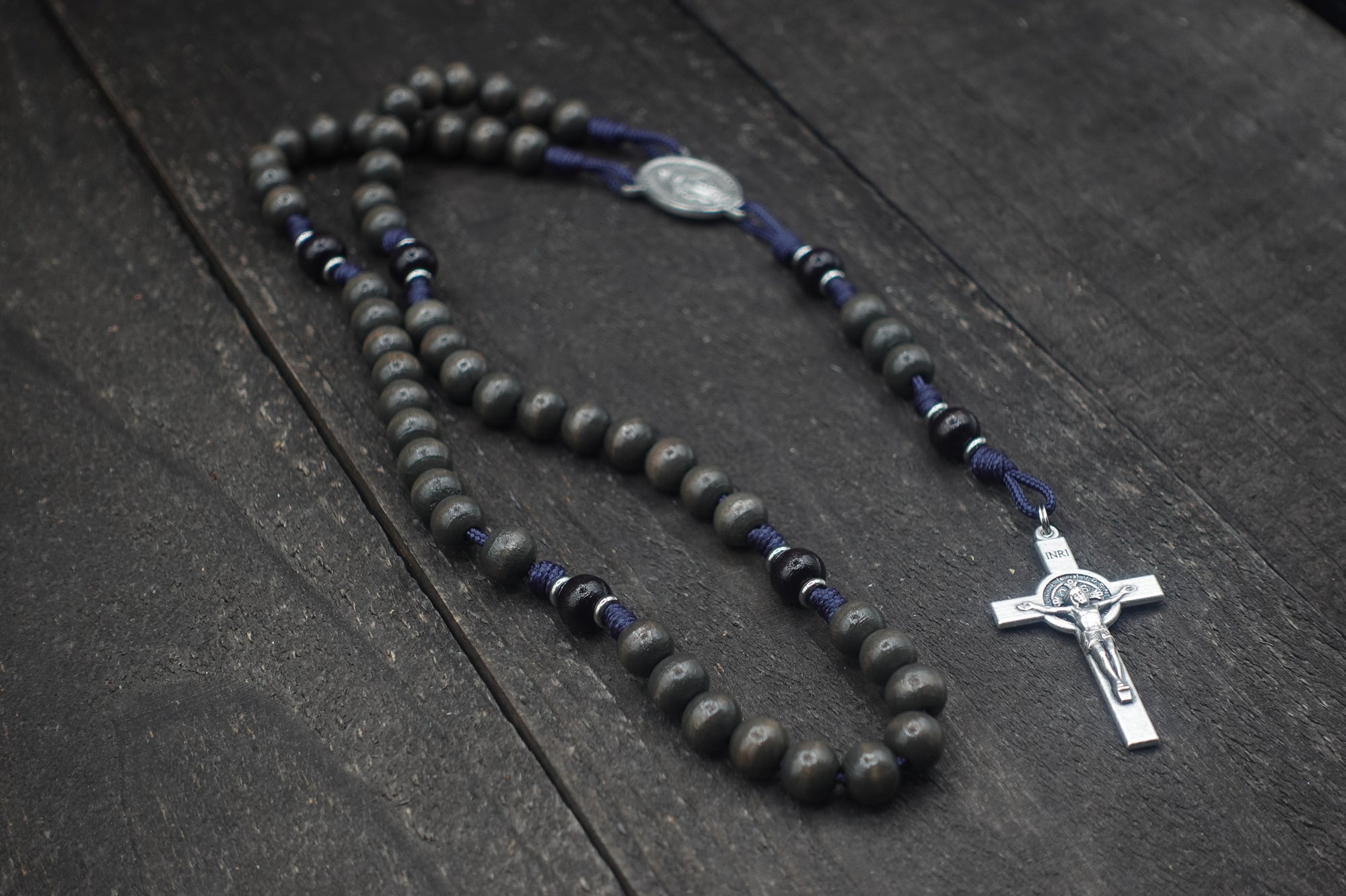 Handcrafted rosary featuring charcoal wood beads, silver crucifix, and Miraculous Medal centerpiece
