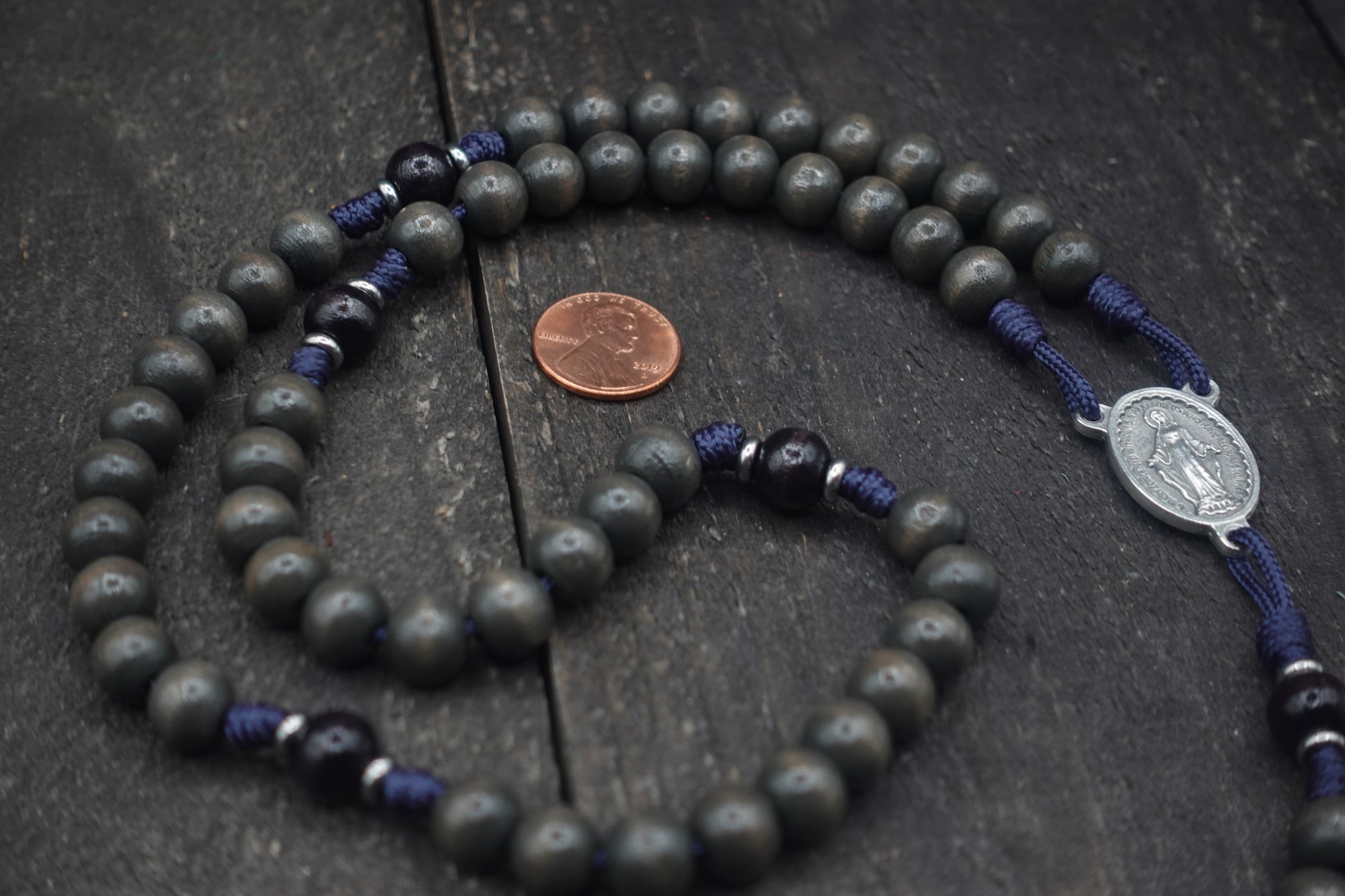 Close-up of charcoal and black wooden beads on Sanctus rosary showing heirloom craftsmanship
