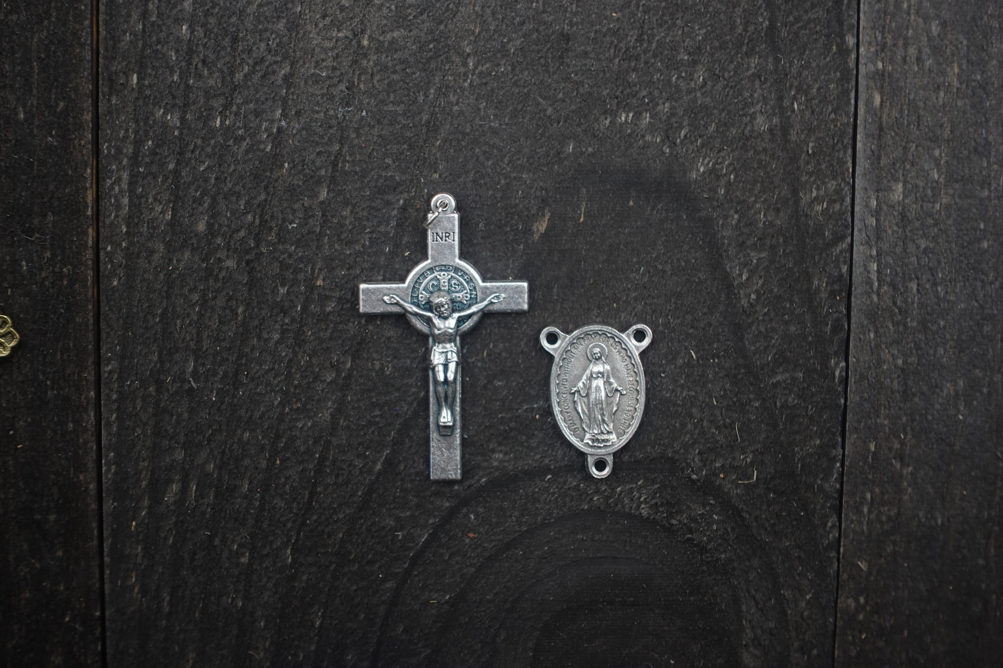 Silver crucifix detail symbolizing strength and devotion on handmade Sanctus rosary