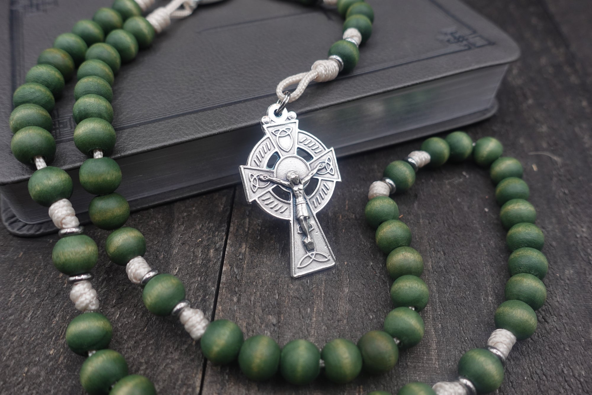 St. Dymphna womens rosary with forest green wooden beads, silver Celtic crucifix, and durable cream paracord
