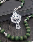 St. Dymphna womens rosary with forest green wooden beads, silver Celtic crucifix, and durable cream paracord