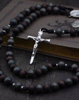 St. Ignatius of Loyola rosary with walnut and charcoal wooden beads, silver Nails crucifix, and black paracord