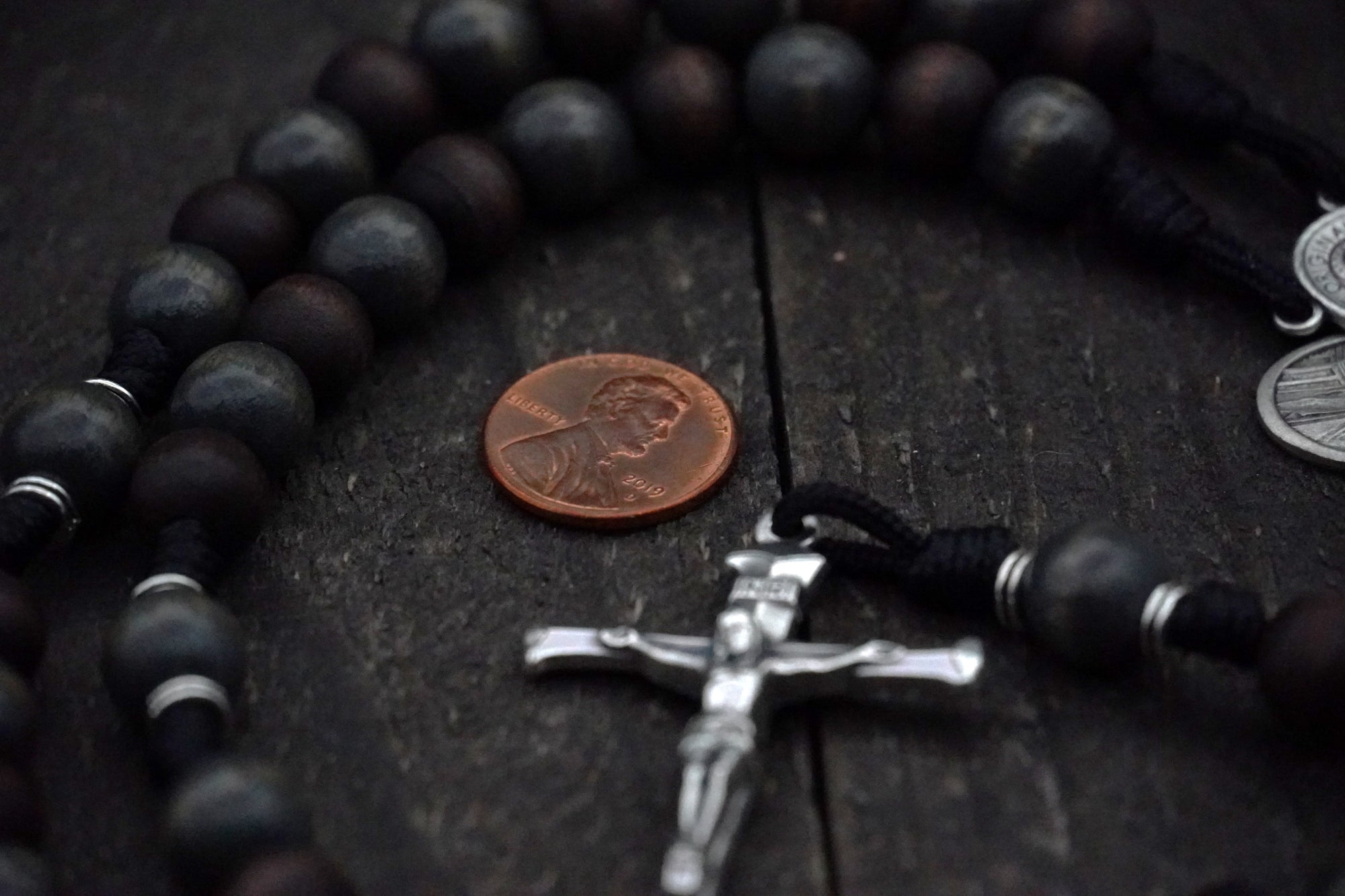 Wood bead detail symbolizing strength and simplicity on handmade St. Ignatius rosary