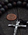 Wood bead detail symbolizing strength and simplicity on handmade St. Ignatius rosary