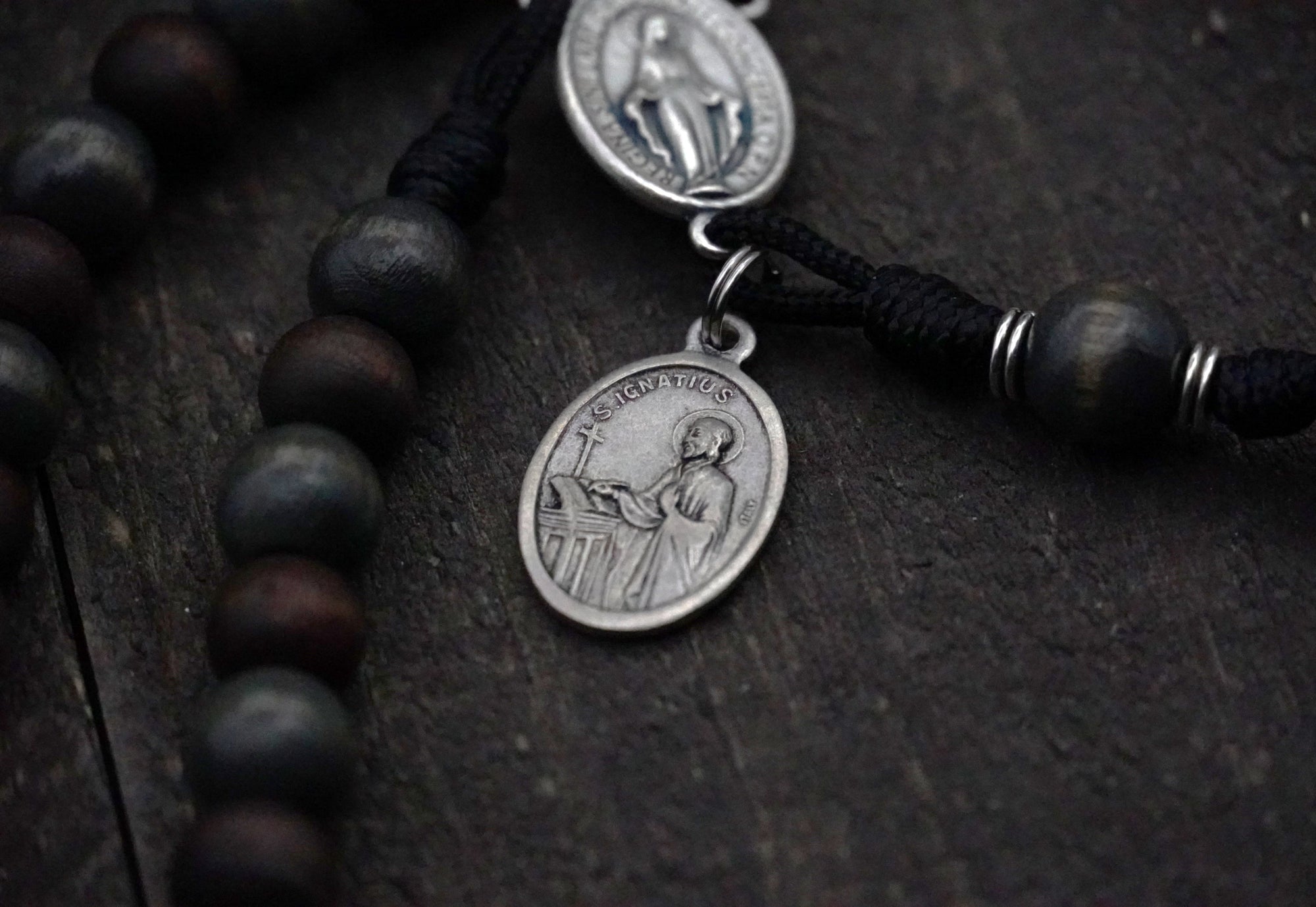 Latin Miraculous Medal centerpiece detail on St. Ignatius rosary with silver hardware and wood beads