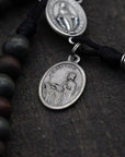 Latin Miraculous Medal centerpiece detail on St. Ignatius rosary with silver hardware and wood beads
