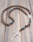 St. Kateri Tekakwitha rosary with gray-brown and teal wooden beads, silver Nails crucifix, and walnut paracord