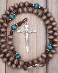 Handcrafted St. Kateri rosary for daily prayer featuring silver crucifix and gray-brown wooden beads