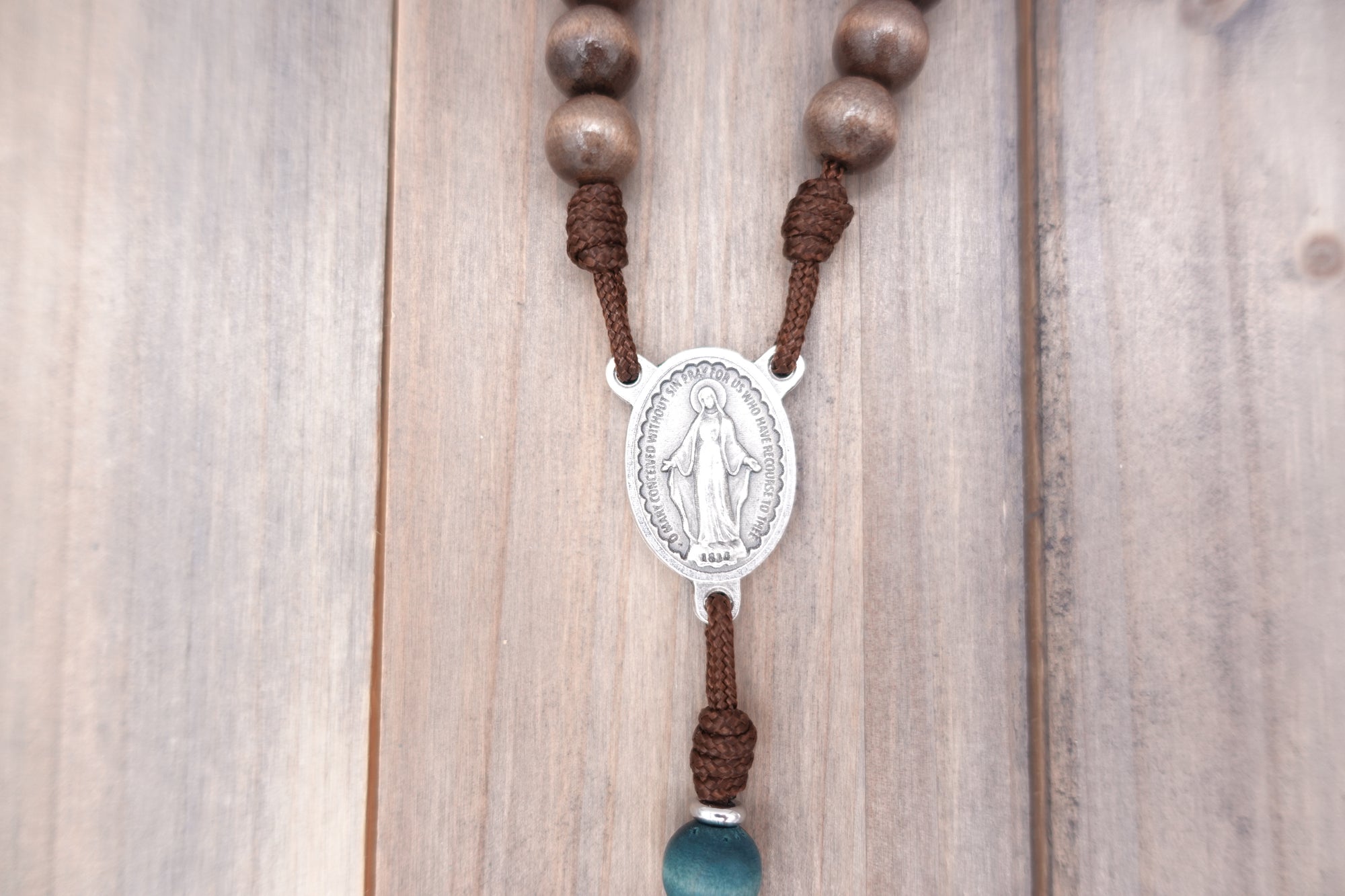 Miraculous Medal centerpiece detail on St. Kateri Tekakwitha rosary with silver hardware and wooden beads