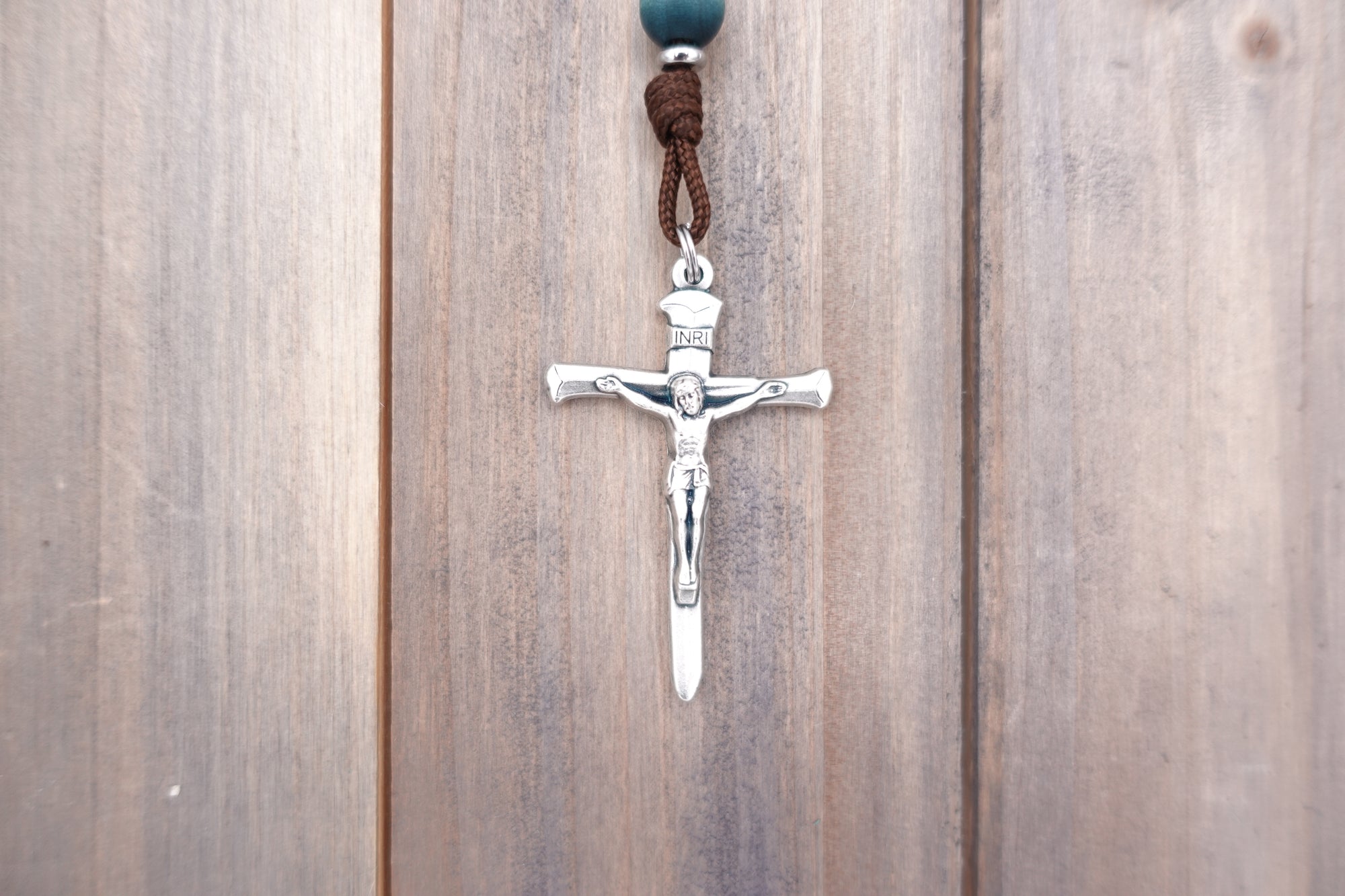 Silver crucifix detail symbolizing strength and faith on handmade St. Kateri Tekakwitha rosary