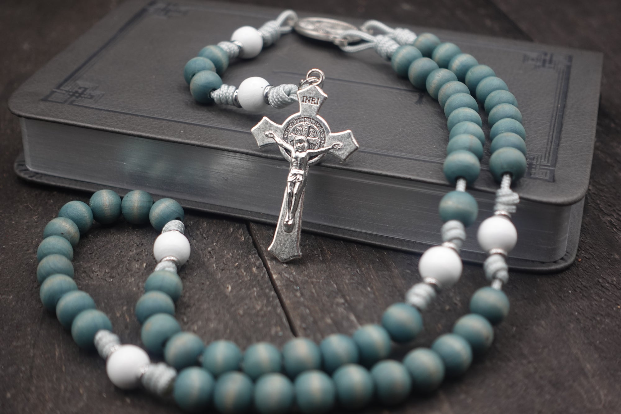 St. Maria Goretti womens rosary with faded blue and white wooden beads, silver St. Benedict crucifix, and silver paracord