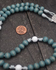 Handcrafted women’s rosary featuring blue and white wood beads with silver crucifix and St. Maria Goretti medal centerpiece
