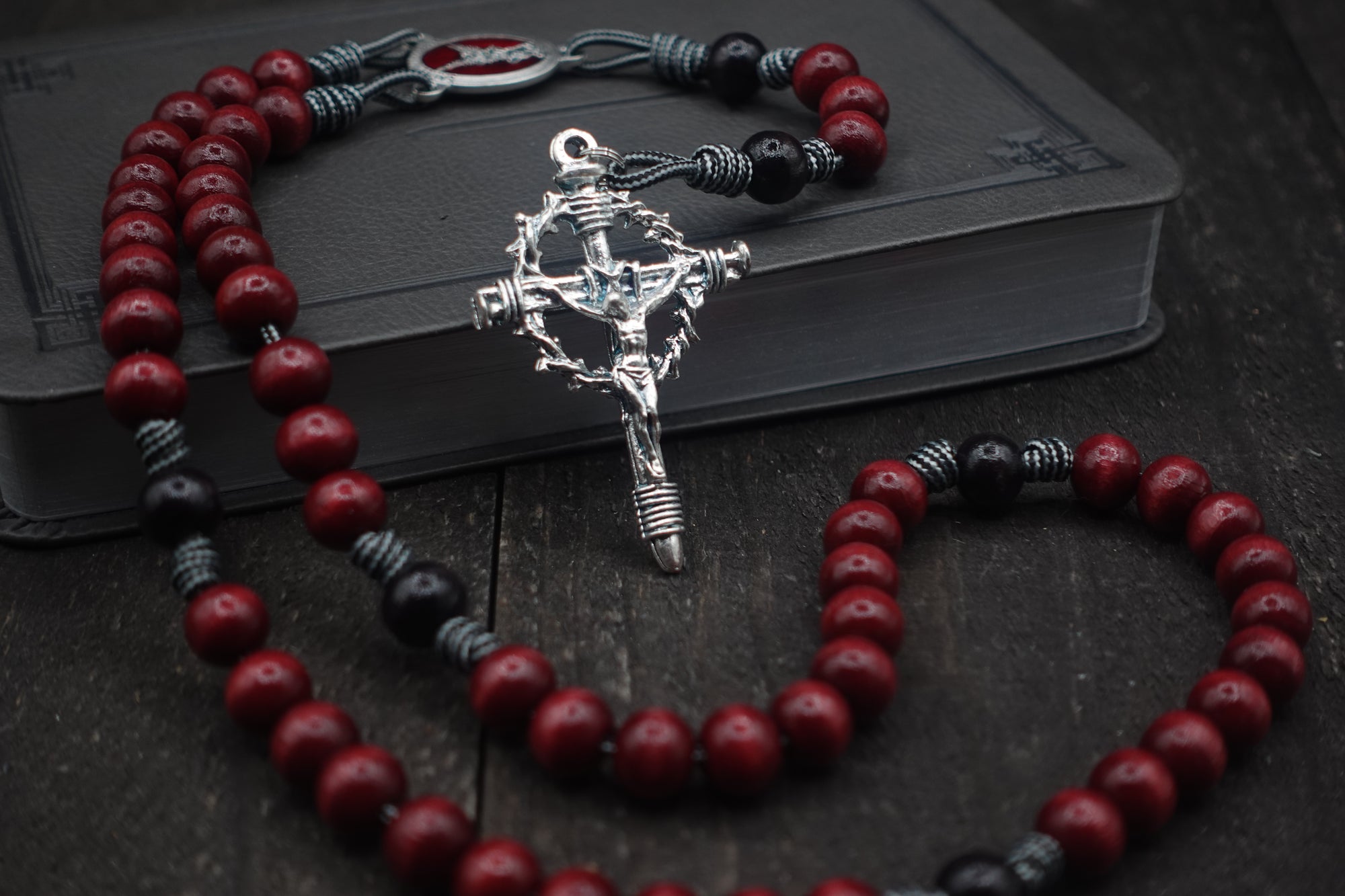 St. Michael rosary with red and black wooden beads, silver Crown of Thorns crucifix, and durable paracord
