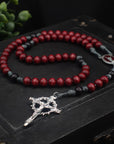 Handcrafted rosary featuring red wood beads, black Our Father beads, and silver crucifix centerpiece